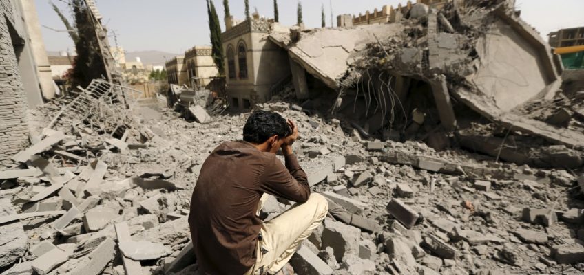 Guard sits on the rubble of the house of Brigadier Fouad al-Emad, an army commander loyal to the Houthis, after air strikes destroyed it in Sanaa, Yemen